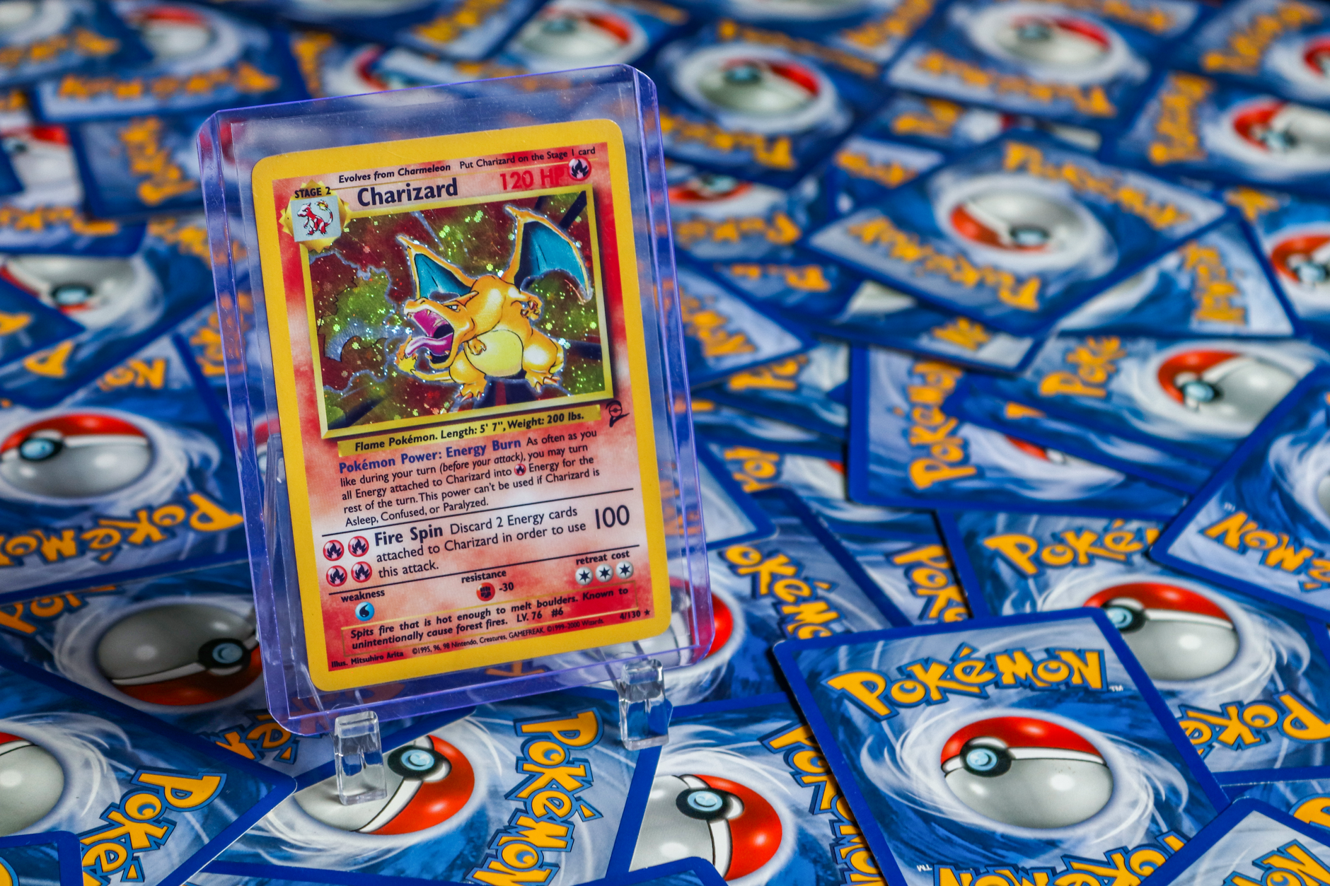 High-value Charizard Pokémon trading card surrounded by various other cards.