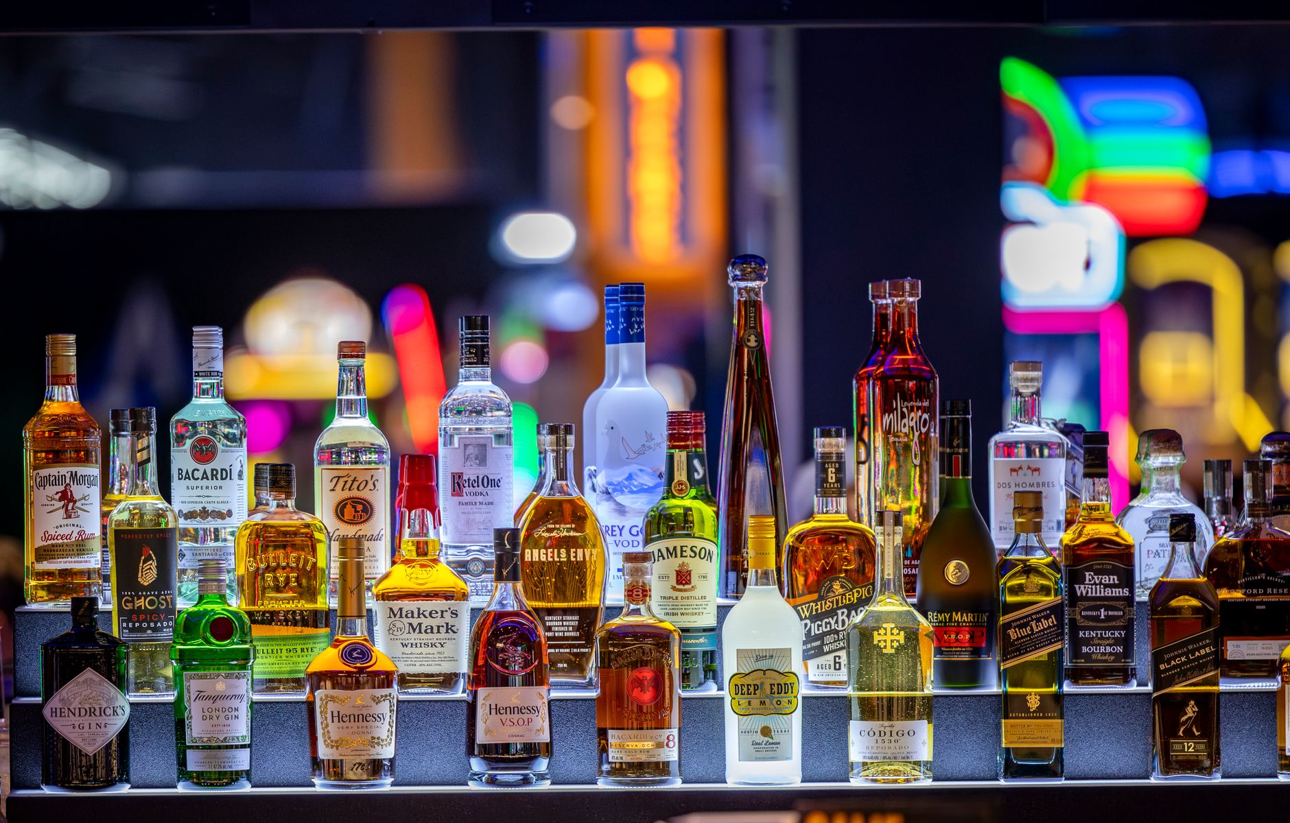 A vibrant selection of liquor bottles on display, creating a colorful and inviting bar atmosphere.