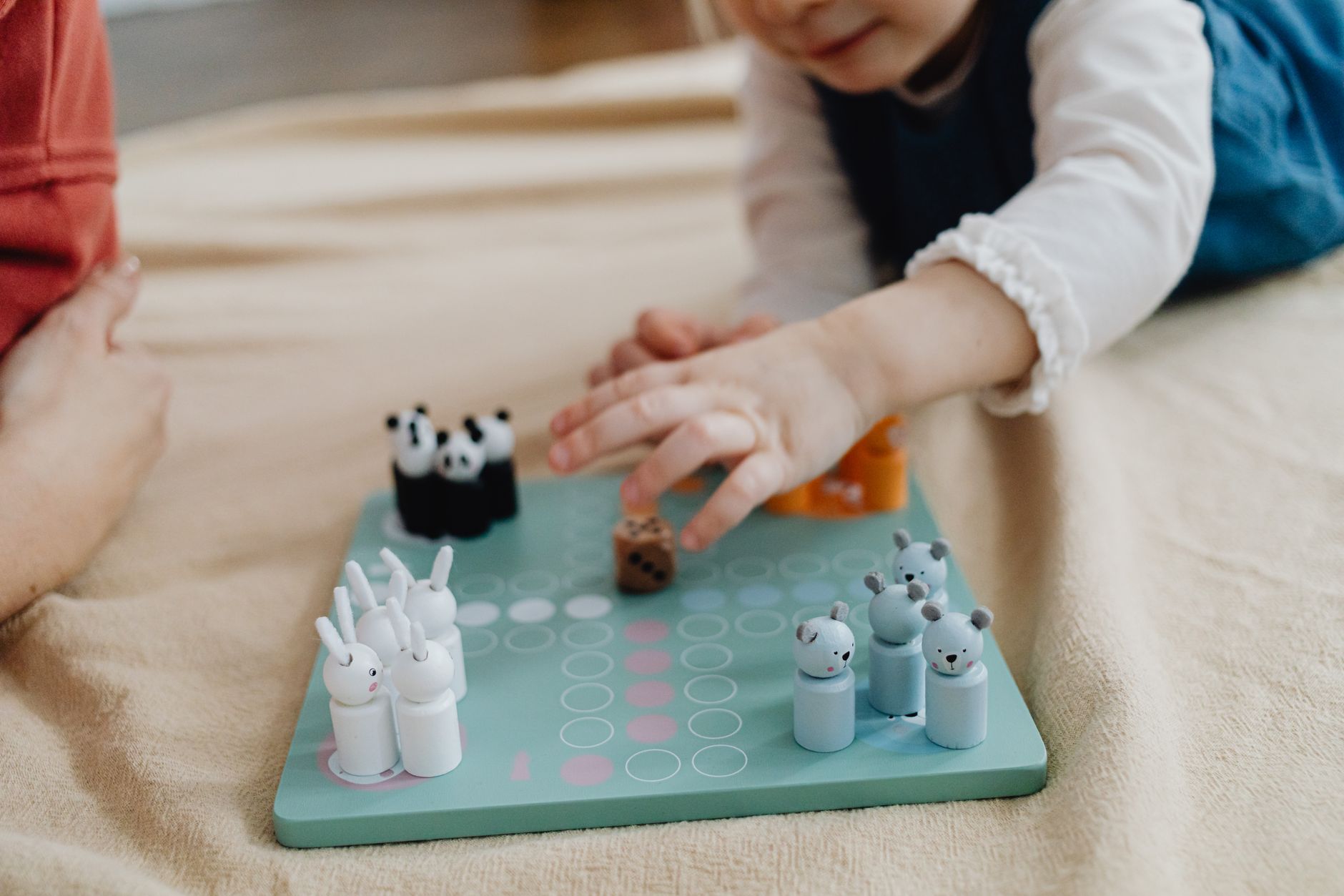 Child enjoying a board game indoors. Perfect candid moment of play and leisure.