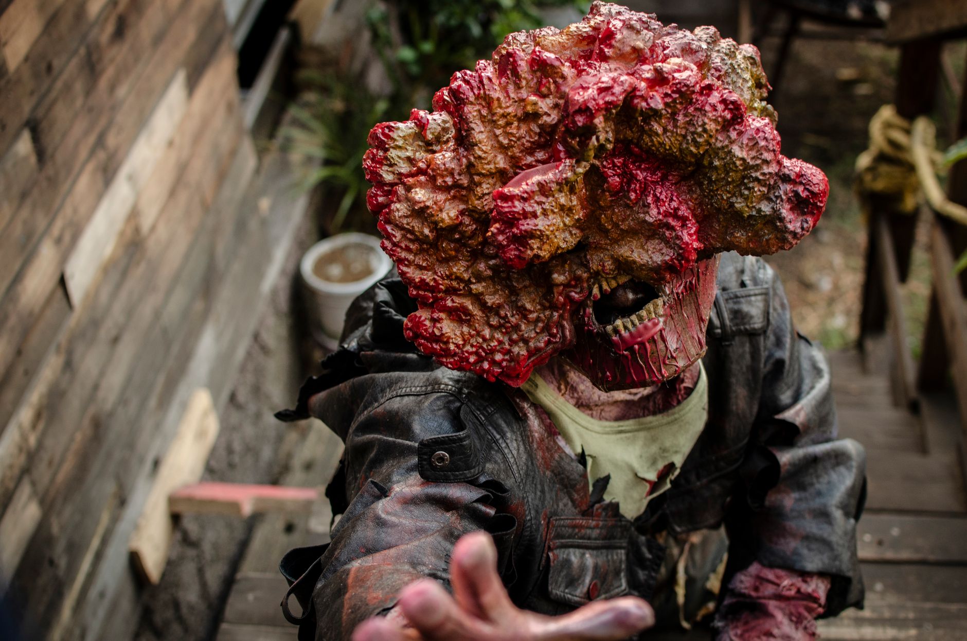 A detailed zombie cosplay costume depicting horror elements in an outdoor setting.