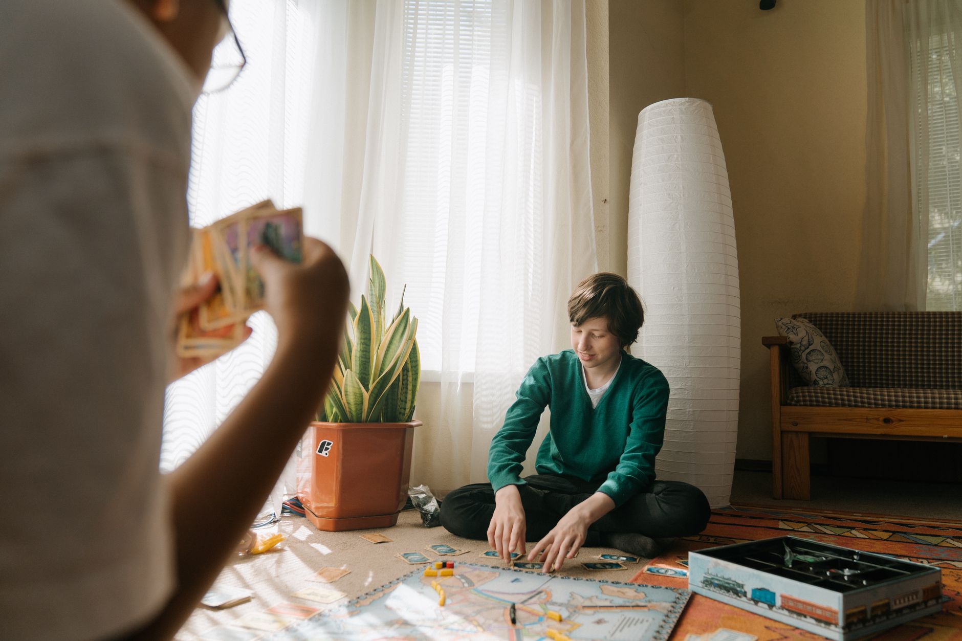 Group playing a board game indoors, focusing on strategy and tactics for leisure and fun.