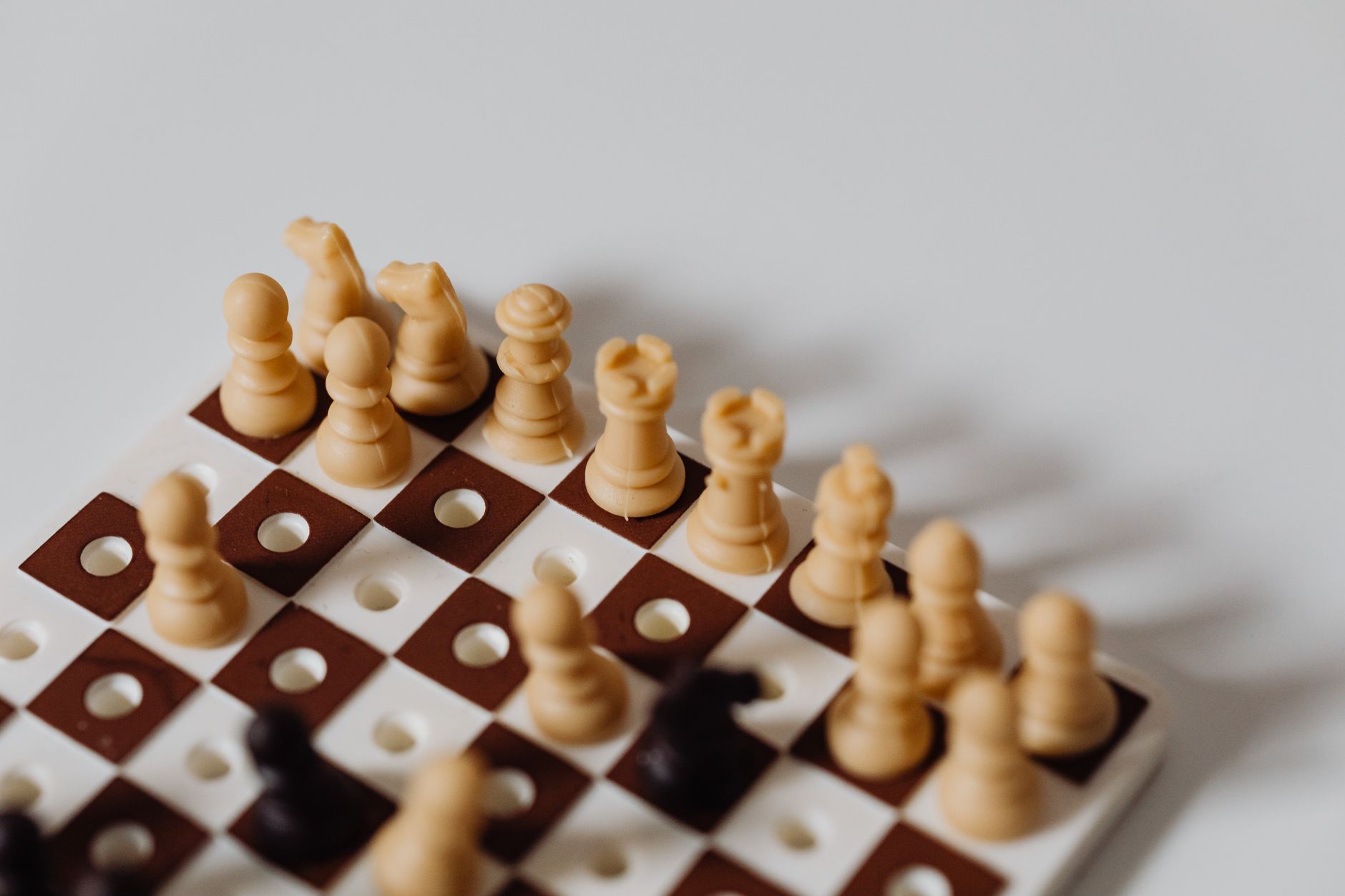 Detailed close-up of chess pieces on a chessboard, perfect for strategy-themed projects.