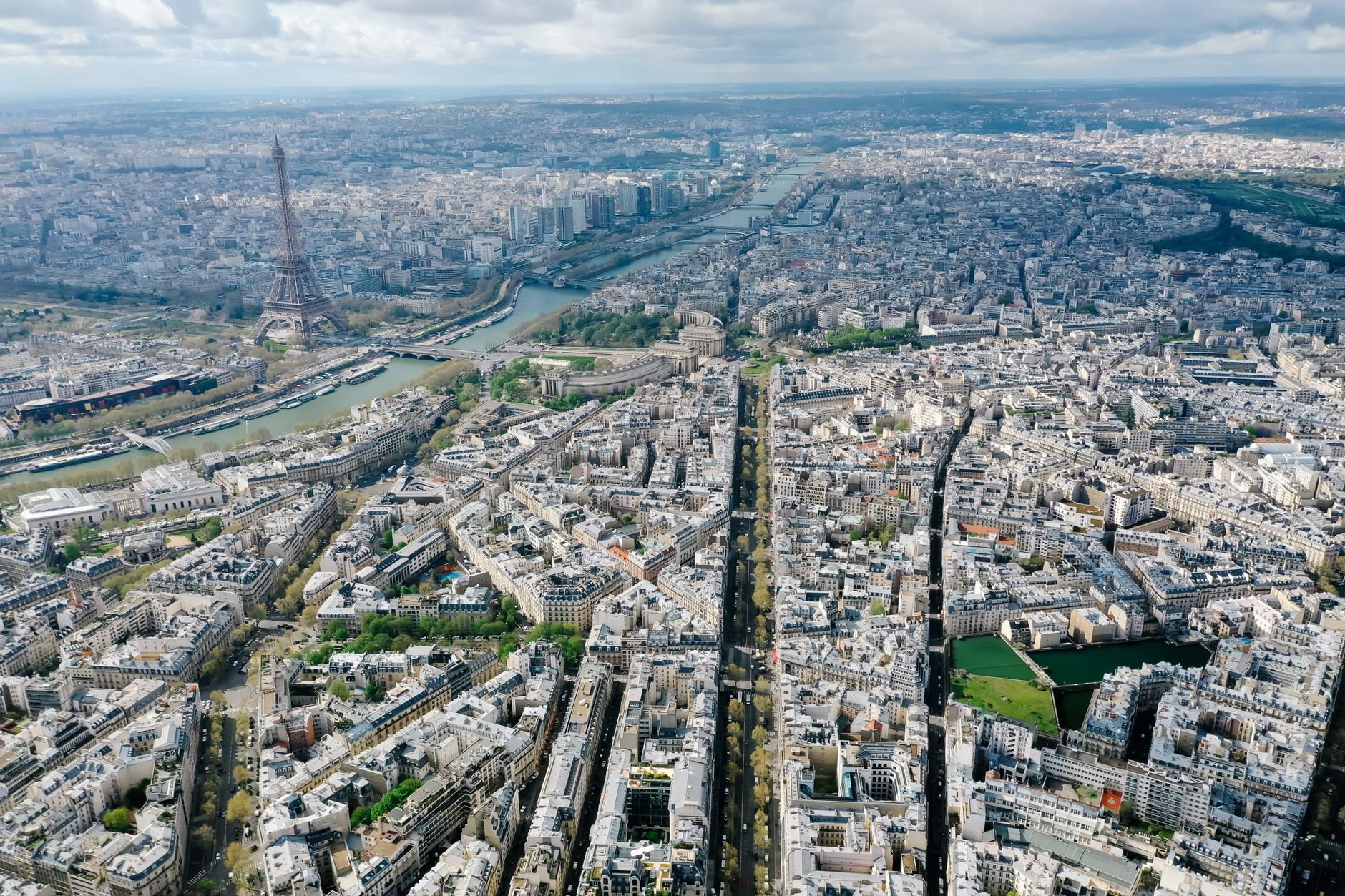 Stunning aerial panorama of Paris featuring the iconic Eiffel Tower and the River Seine.