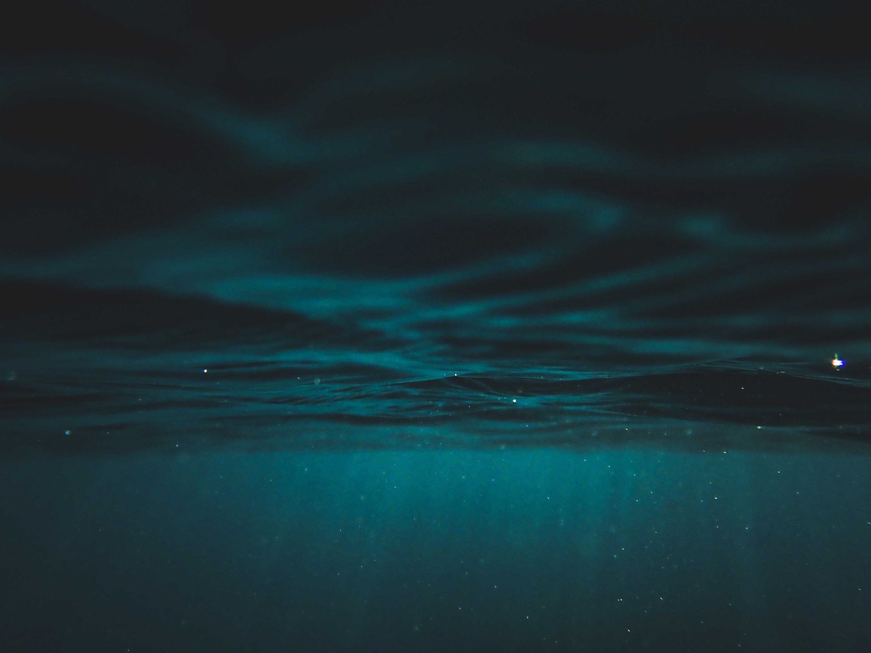 Captivating underwater ocean view with deep blue hues and serene ambiance.