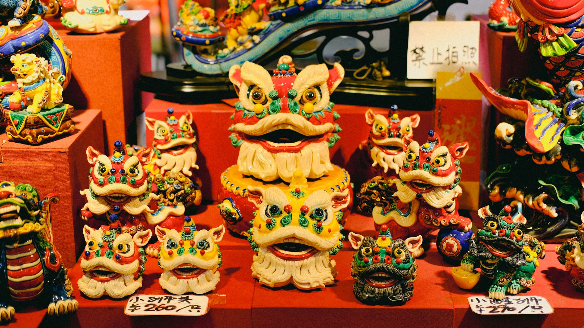 Vibrant dragon figurines on display at an Asian cultural market.