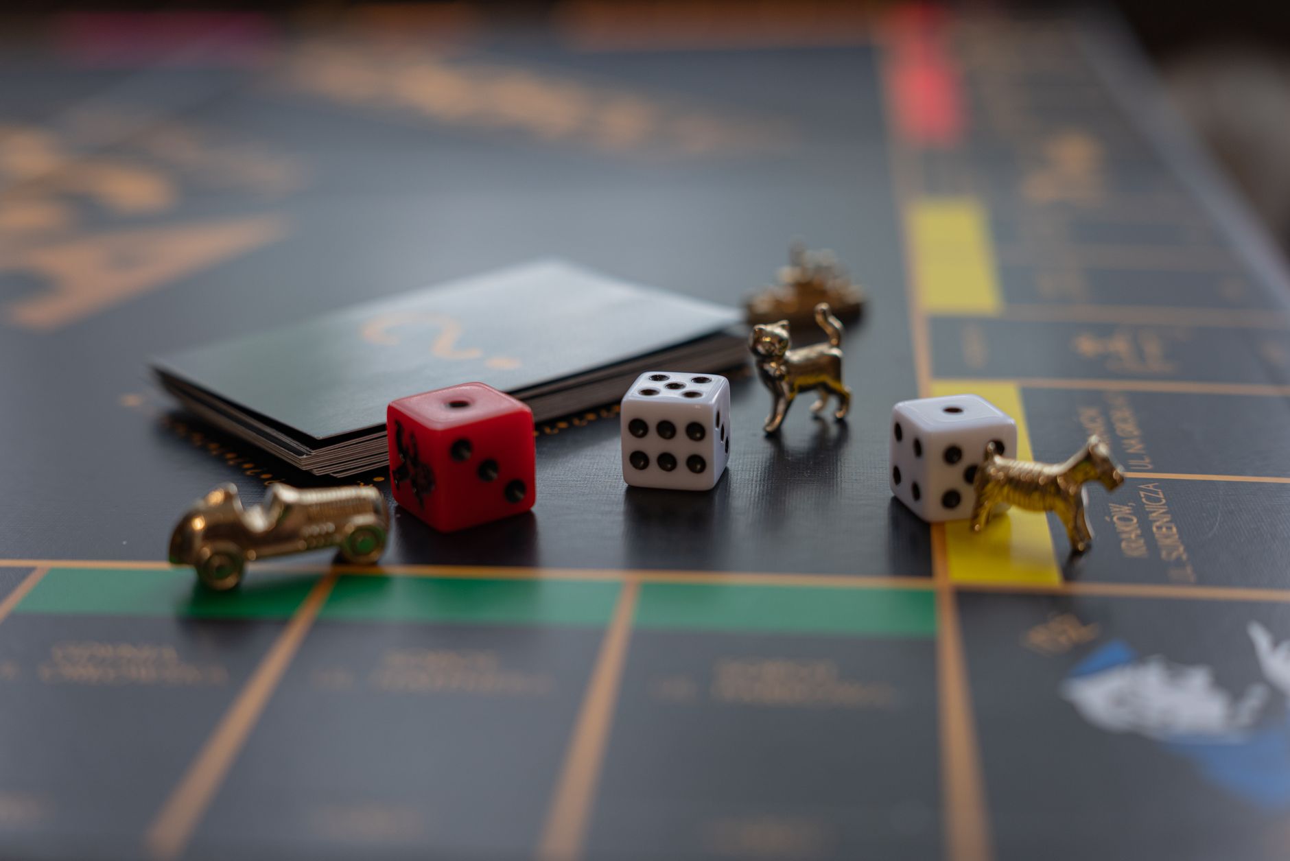 Close-up of Monopoly board game pieces including dice and tokens, perfect for family game night themes.