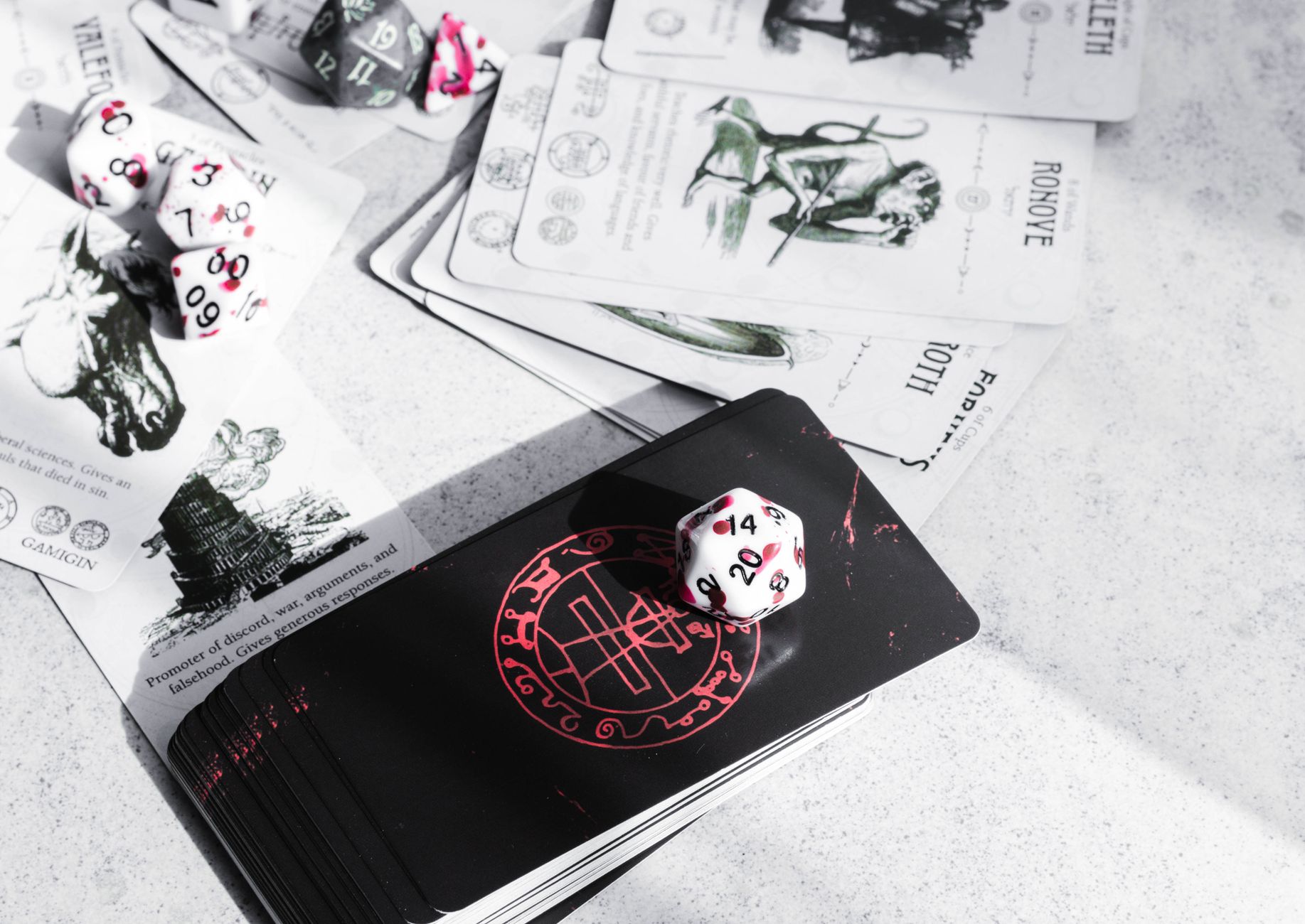 A collection of tarot cards and gaming dice on a tabletop, featuring mystical illustrations.