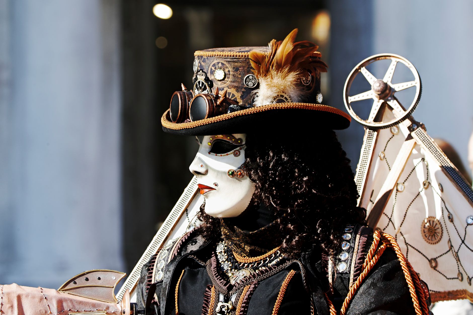 A person in an elaborate steampunk costume and mask, featuring gears and goggles.