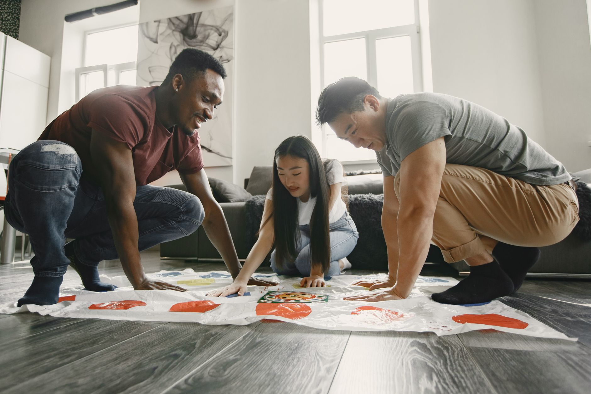A diverse group of friends playing a lively indoor game, sharing laughter and excitement.