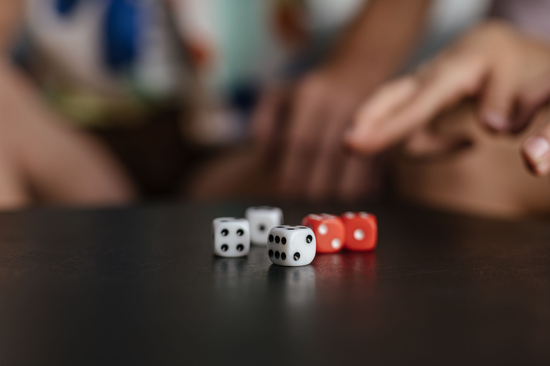 Close-up view of colorful dice on a table, capturing the essence of luck and chance.